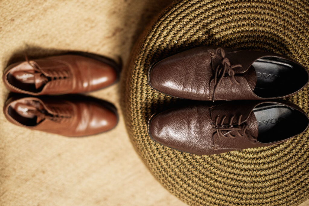 Two pairs of brown leather dress shoes side by side at Las Caletas wedding, Puerto Vallarta