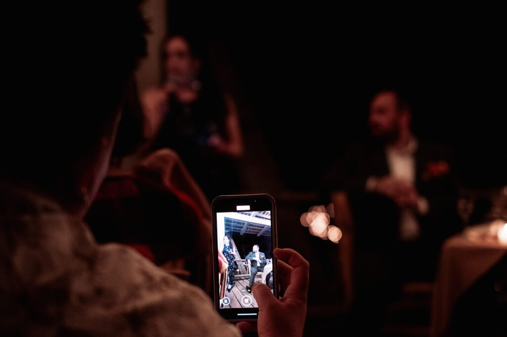 Guest filming wedding reception moment on smartphone at Las Caletas, Puerto Vallarta