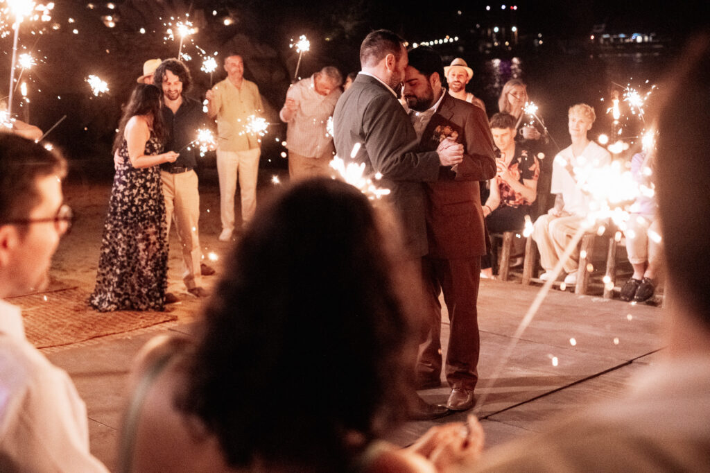 Two grooms share first dance surrounded by sparklers at Las Caletas wedding reception, Puerto Vallarta