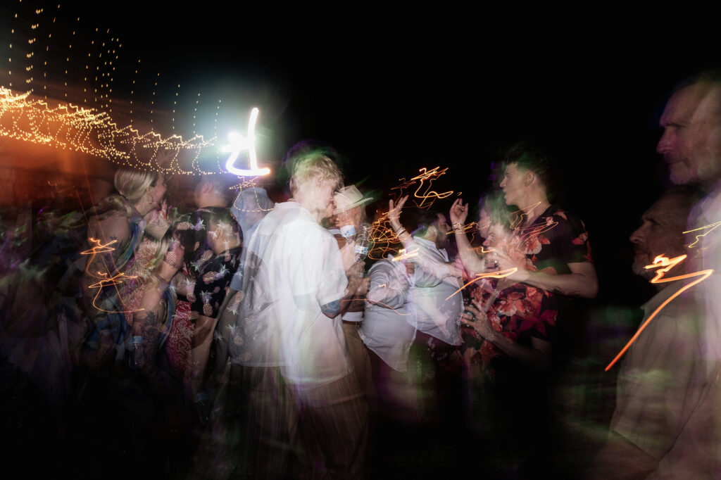 Wedding guests waving sparklers at night reception, Las Caletas Puerto Vallarta, documentary photography
