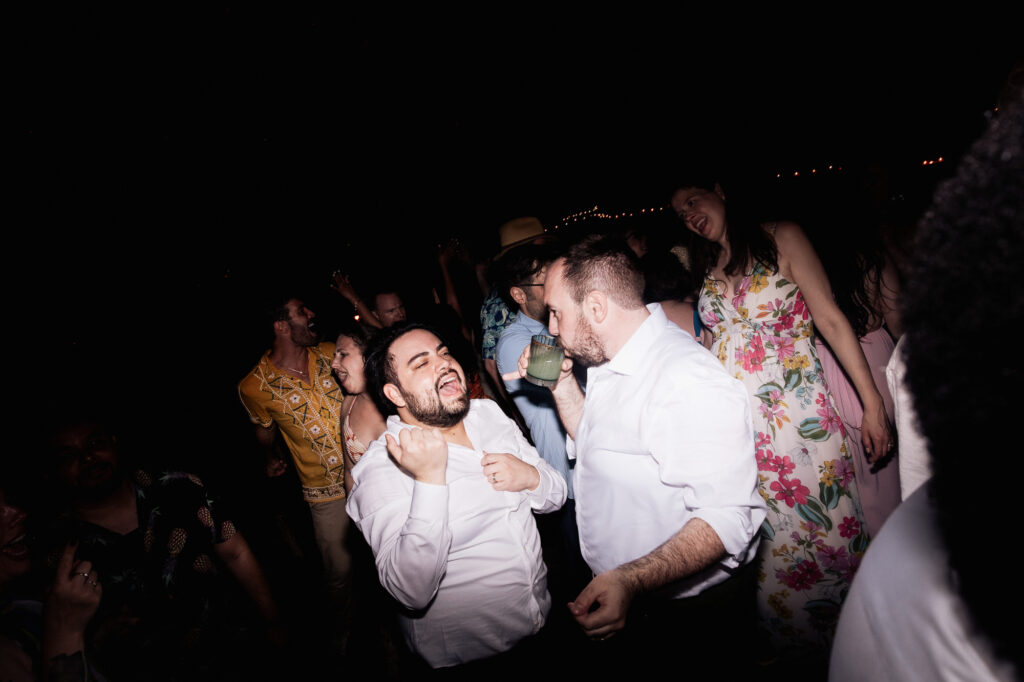 Guests dancing joyfully at night wedding reception, Las Caletas Puerto Vallarta