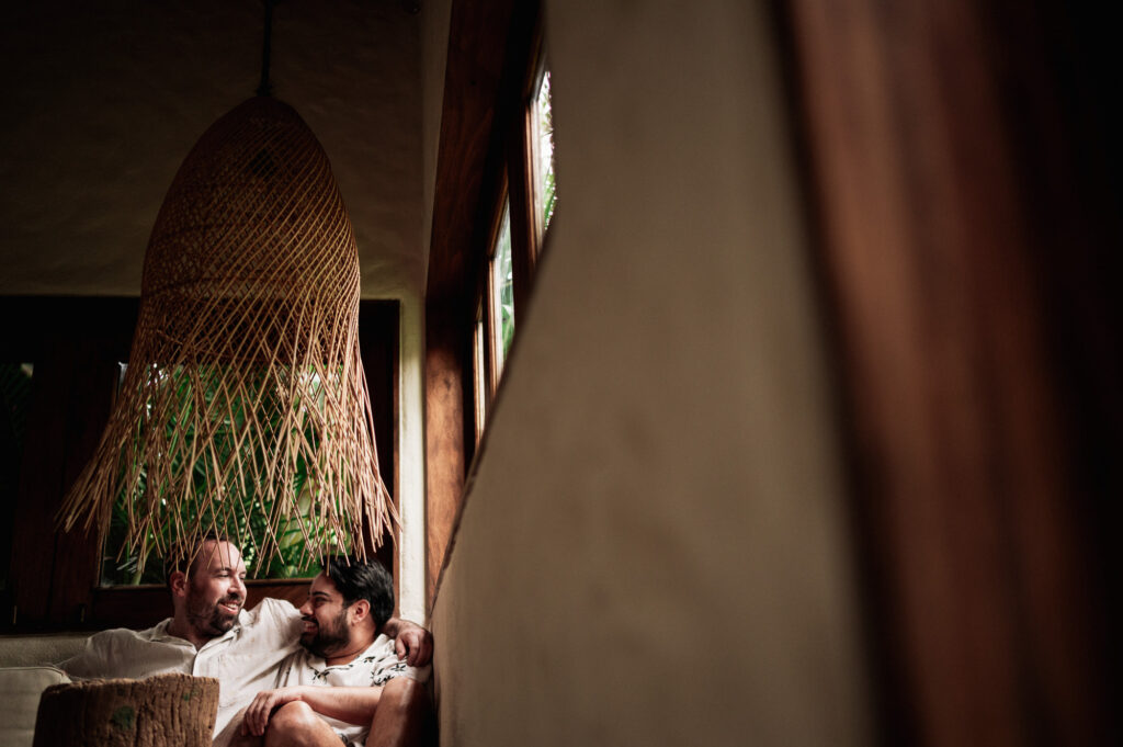 Two grooms sharing a quiet moment indoors at Las Caletas Puerto Vallarta wedding