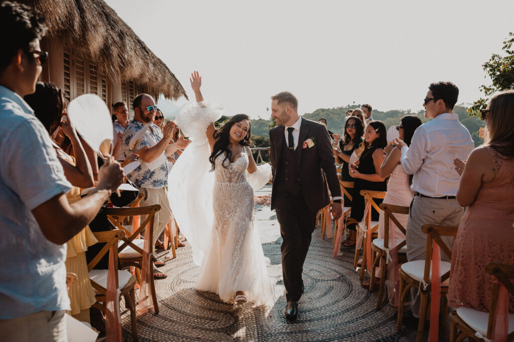 Bride and groom walk down the aisle at Villa Valentin Sayulita wedding ceremony, guests cheering