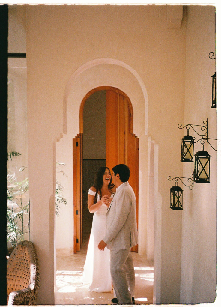 Bride and groom laughing together at Ambre & Epieces Tulum, shot on 35mm film by wedding photographer