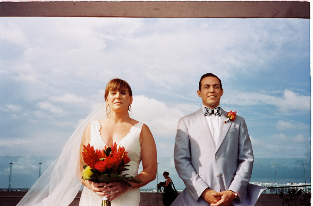 Bride and groom portrait on rooftop at Dreams Vista Cancun wedding ceremony, film photography by Alex Obregón