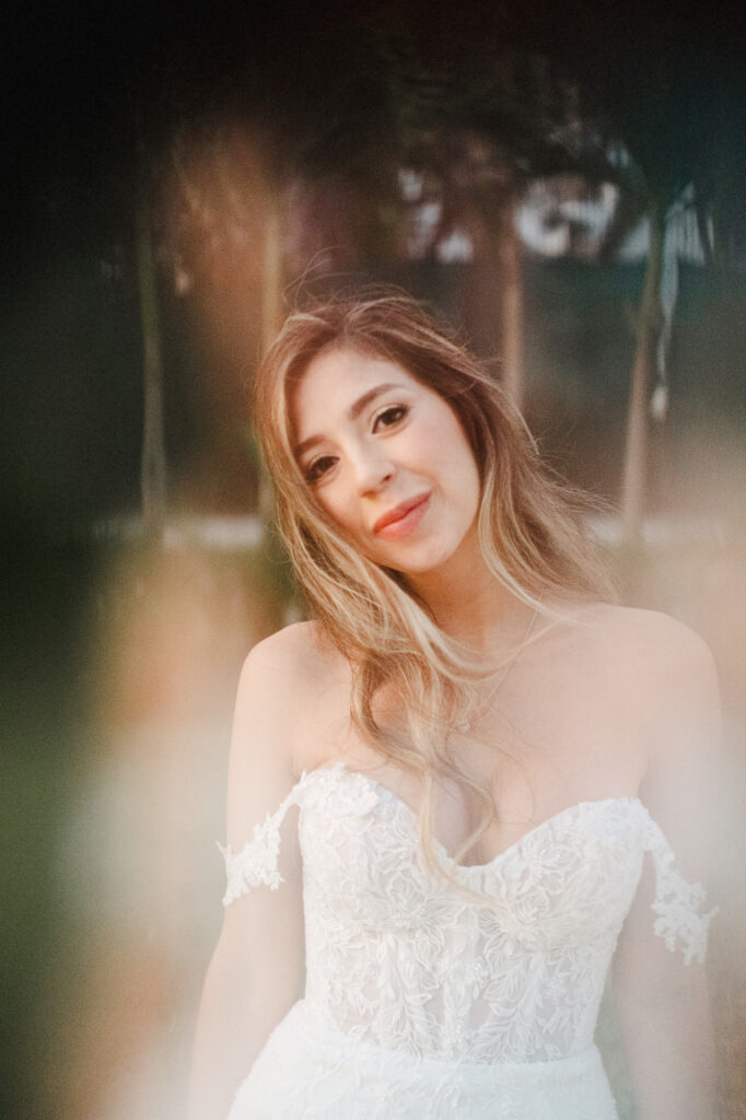 Bride in off-shoulder lace gown smiling softly during wedding ceremony in Puerto Vallarta, Mexico