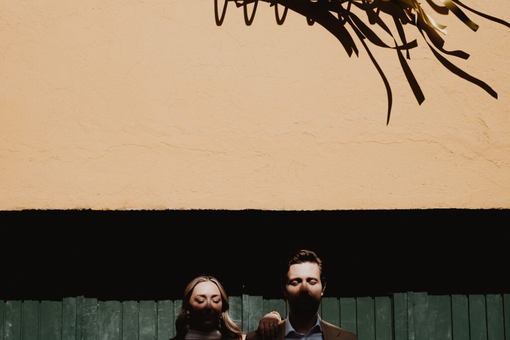 Couple in shadow against terracotta wall, San Miguel de Allende wedding, documentary film photography