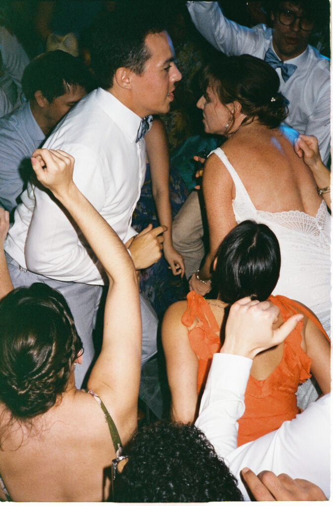 Guests dancing at wedding reception, Dreams Vista Cancun, shot on 35mm film by documentary photographer