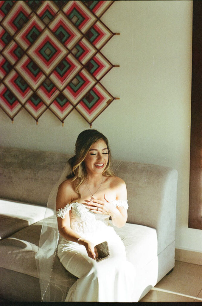 Bride in off-shoulder lace gown laughing softly before ceremony, Puerto Vallarta wedding, 35mm film
