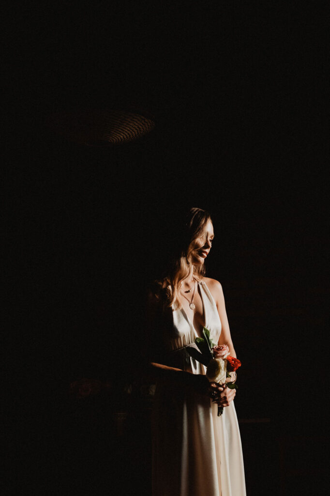 Bride in white gown holding roses at Villa del Sol, Sayulita wedding ceremony, documentary film photography