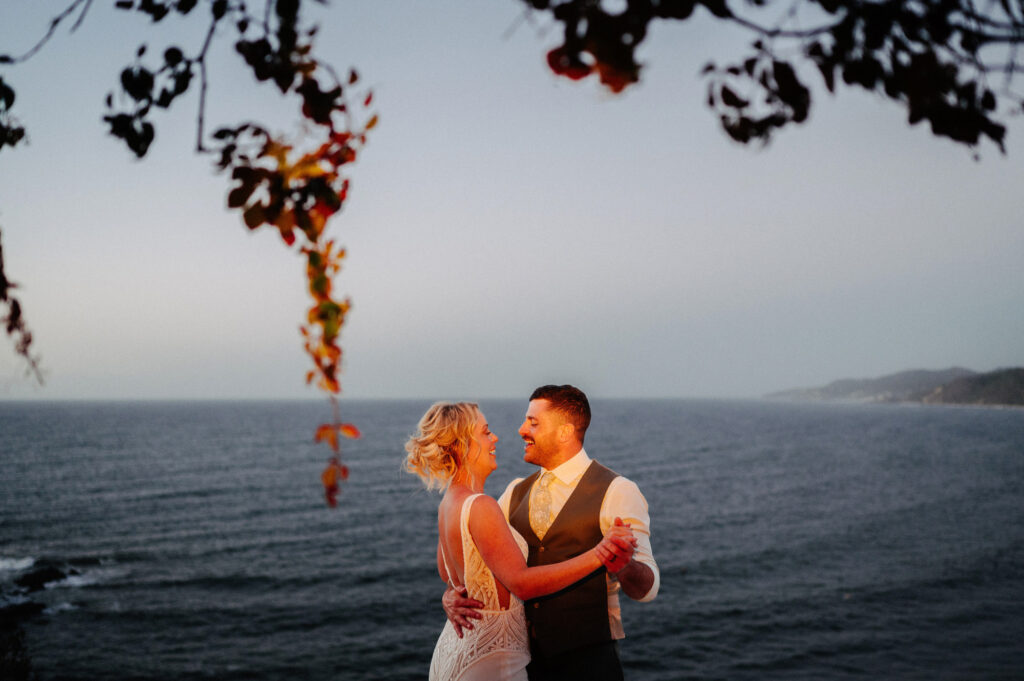 Bride and groom dancing at sunset overlooking the ocean at Villa Amor, Sayulita wedding reception
