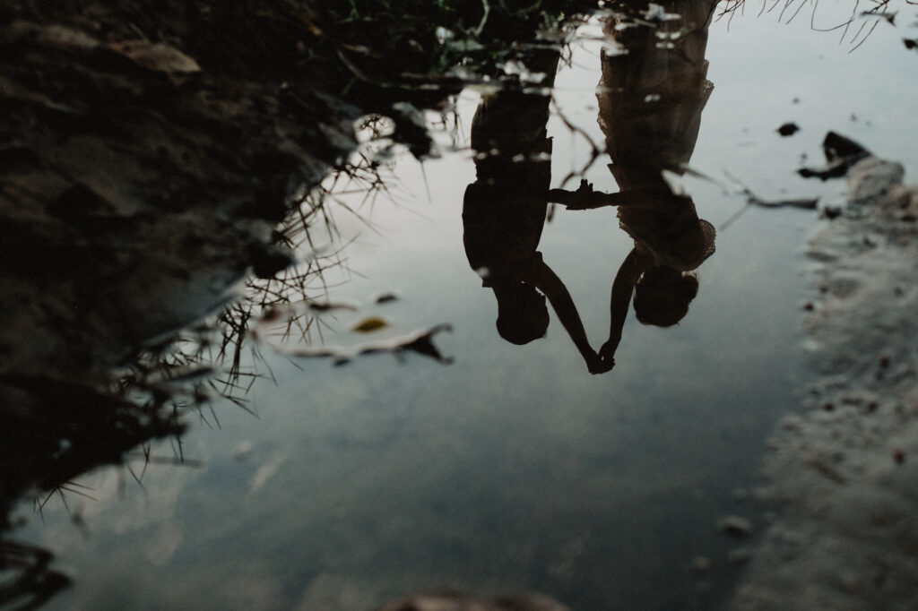 Couple silhouette reflected in water during engagement session in Sayulita, Mexico, film photography style