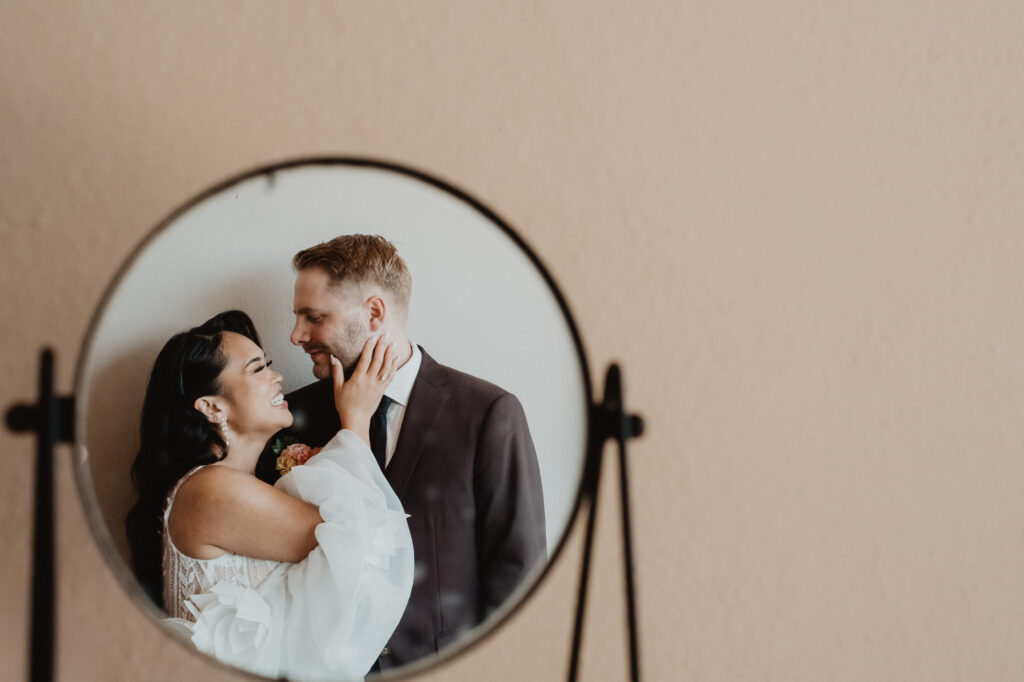 Bride and groom reflected in round mirror at Villa Valentin Sayulita wedding, documentary style