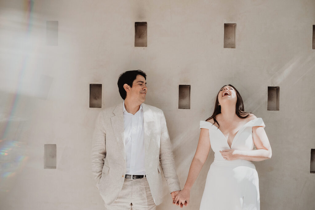 Bride laughing joyfully with groom at Ambre & Epieces Tulum wedding ceremony, documentary film photography
