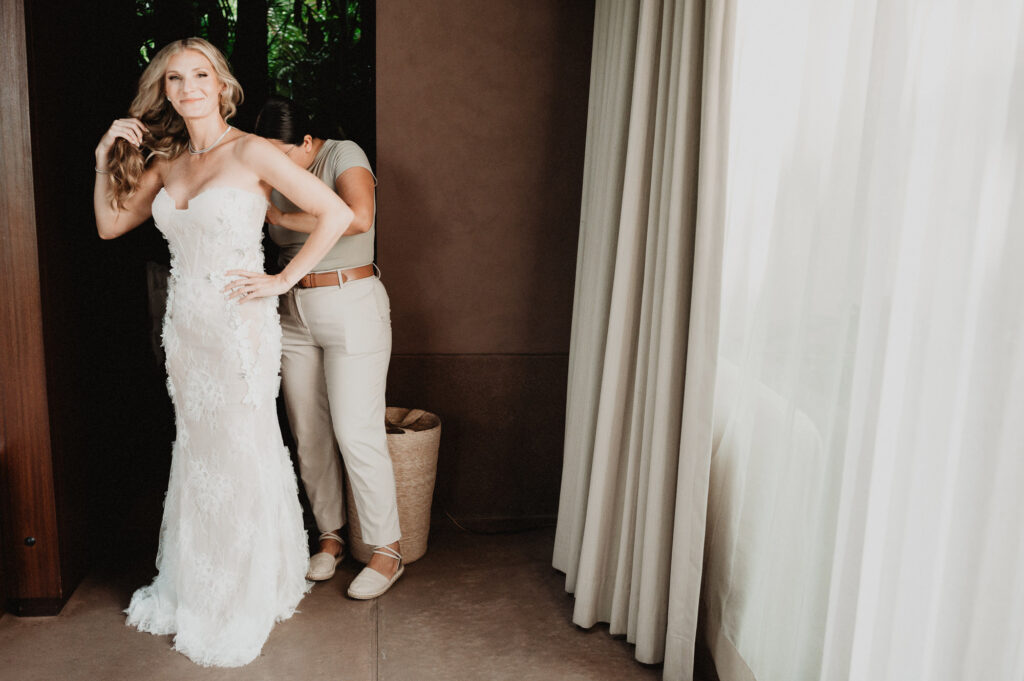 Bride getting dressed at One&Only Mandarina, elopement wedding photography by Alex Obregón, Mexico