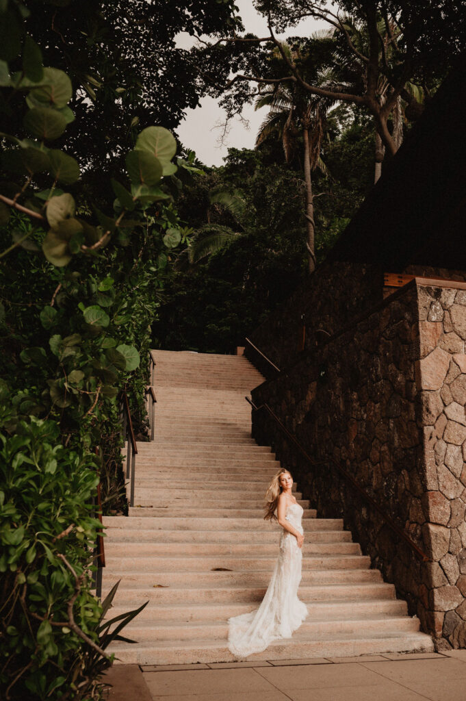Bride in lace gown on stone steps at One&Only Mandarina, elopement wedding photo by Alex Obregón