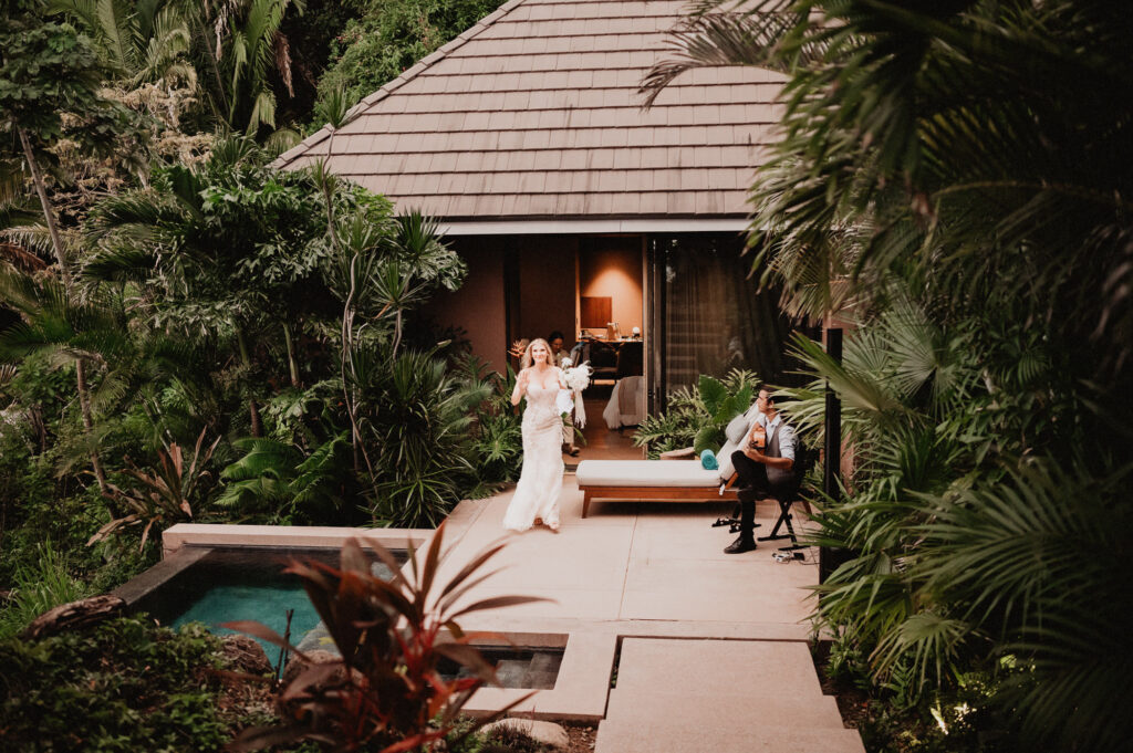 Bride in lace gown walking through lush jungle villa at One&Only Mandarina elopement, Mexico