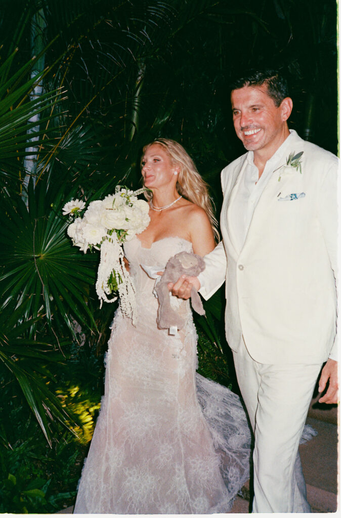 Bride and groom walk joyfully after elopement at One&Only Mandarina, Mexico, shot on 35mm film