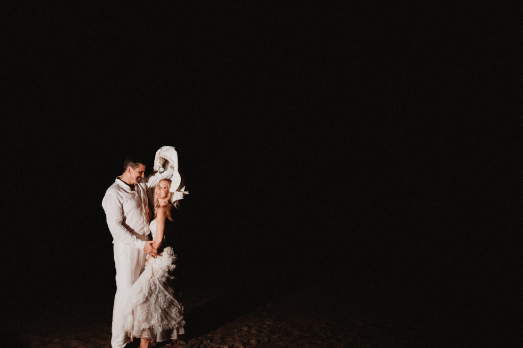 Couple embracing at night on the beach at One&Only Mandarina, elopement wedding photo by Alex Obregón