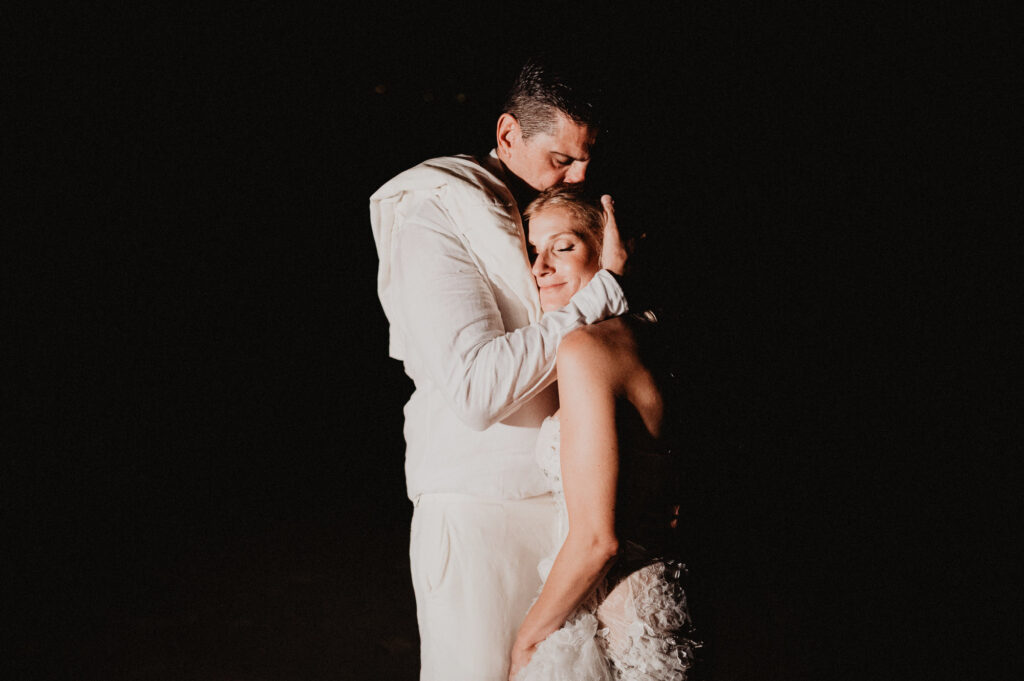 Bride and groom embrace at night during elopement at One&Only Mandarina, Mexico