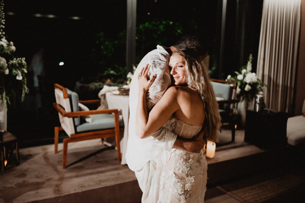 Bride smiling during first dance embrace at One&Only Mandarina elopement, candlelit reception in Mexico