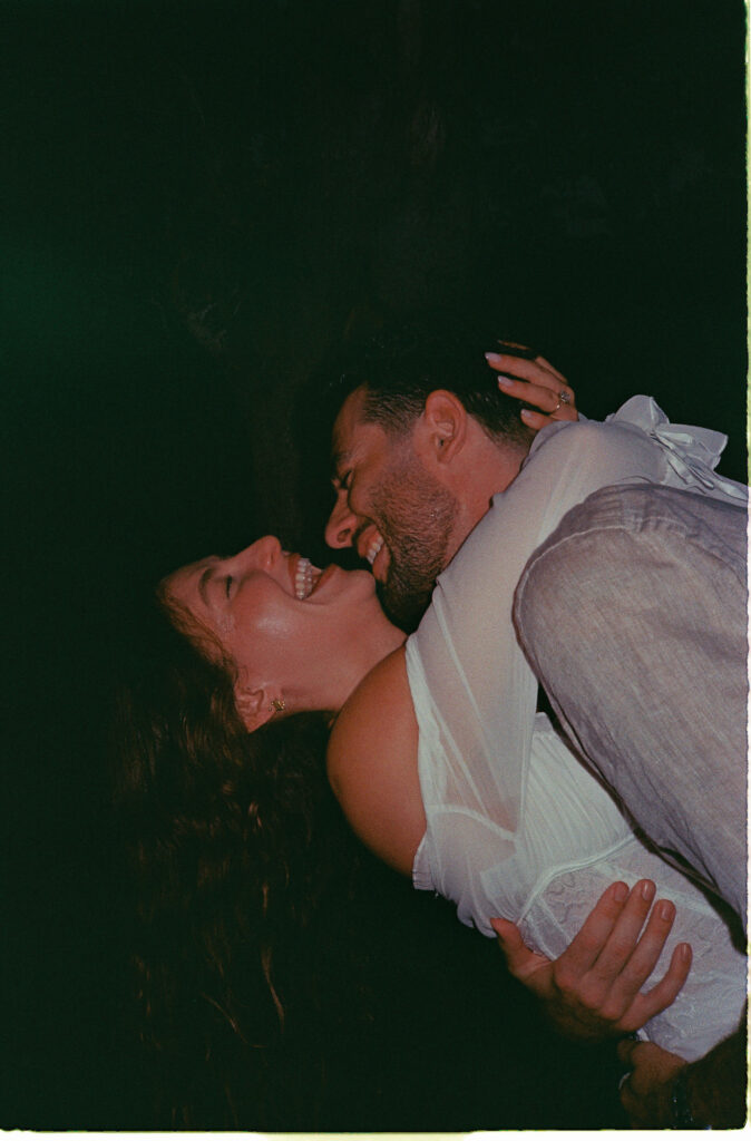 Couple laughing during engagement session in Puerto Vallarta, shot on 35mm film by Alex Obregón