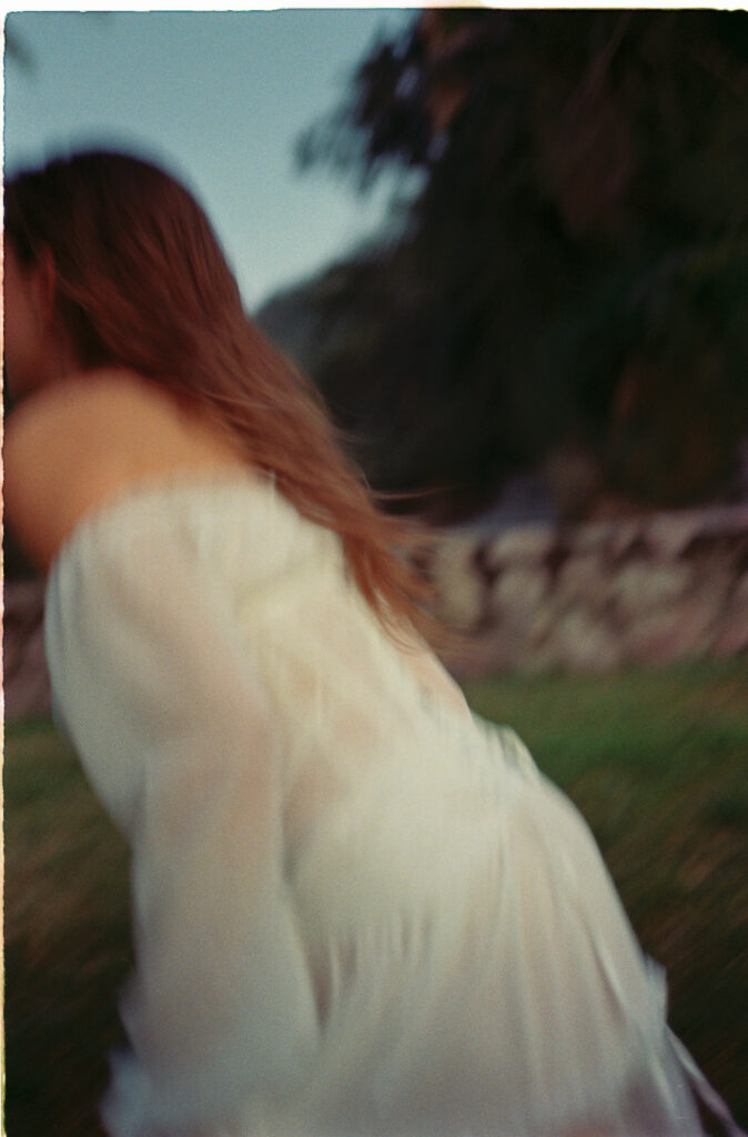 Woman in white dress with auburn hair, engagement session in Puerto Vallarta by film photographer Alex Obregón