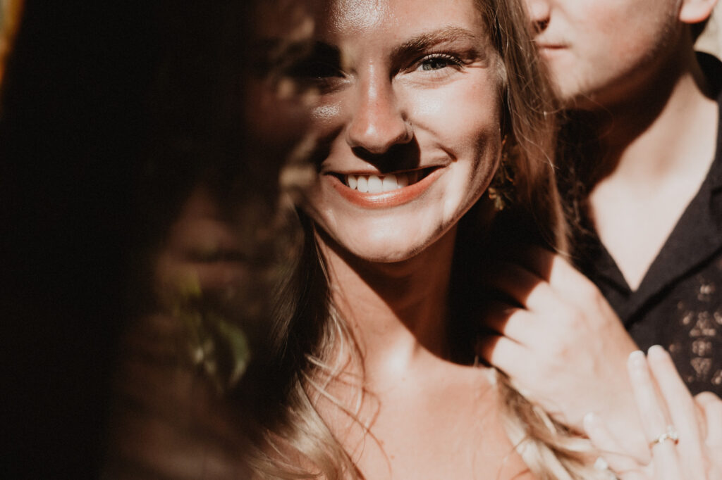 Woman smiling warmly during engagement session at Casa Cosmos Puerto Vallarta, golden light, documentary style