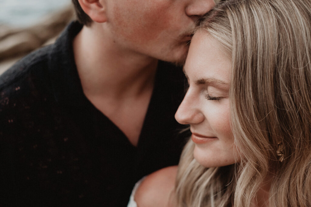 Couple sharing a tender forehead kiss during engagement session at Casa Cosmos, Puerto Vallarta