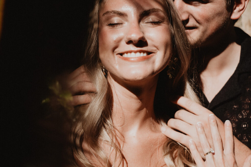 Engaged couple embracing at Casa Cosmos Puerto Vallarta, woman smiling with diamond ring visible
