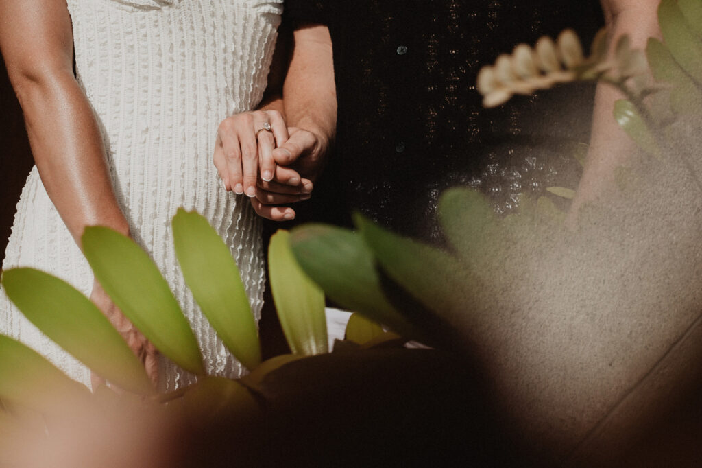 Couple holding hands with engagement ring detail at Casa Cosmos Puerto Vallarta pre wedding session
