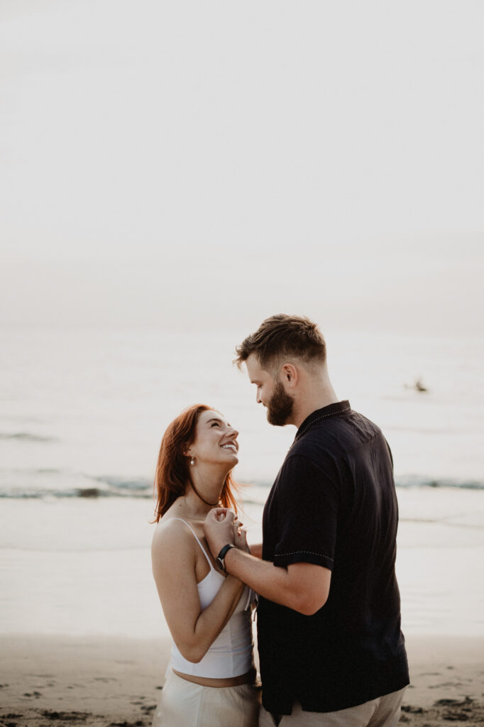 Couple laughing together on the beach during engagement session in Puerto Vallarta, Mexico