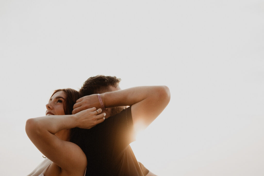 Couple embracing at golden hour during engagement session in Puerto Vallarta, Mexico
