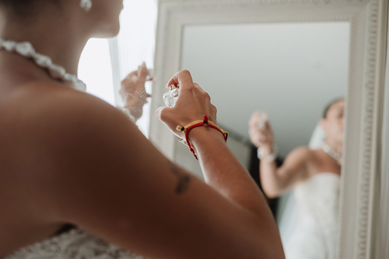 Bride spraying perfume before wedding ceremony at Hilton Riviera Vallarta, Puerto Vallarta