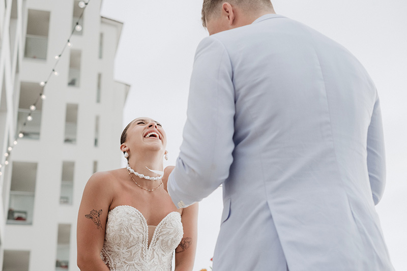 Bride laughing joyfully during wedding ceremony at Hilton Riviera Vallarta, Puerto Vallarta