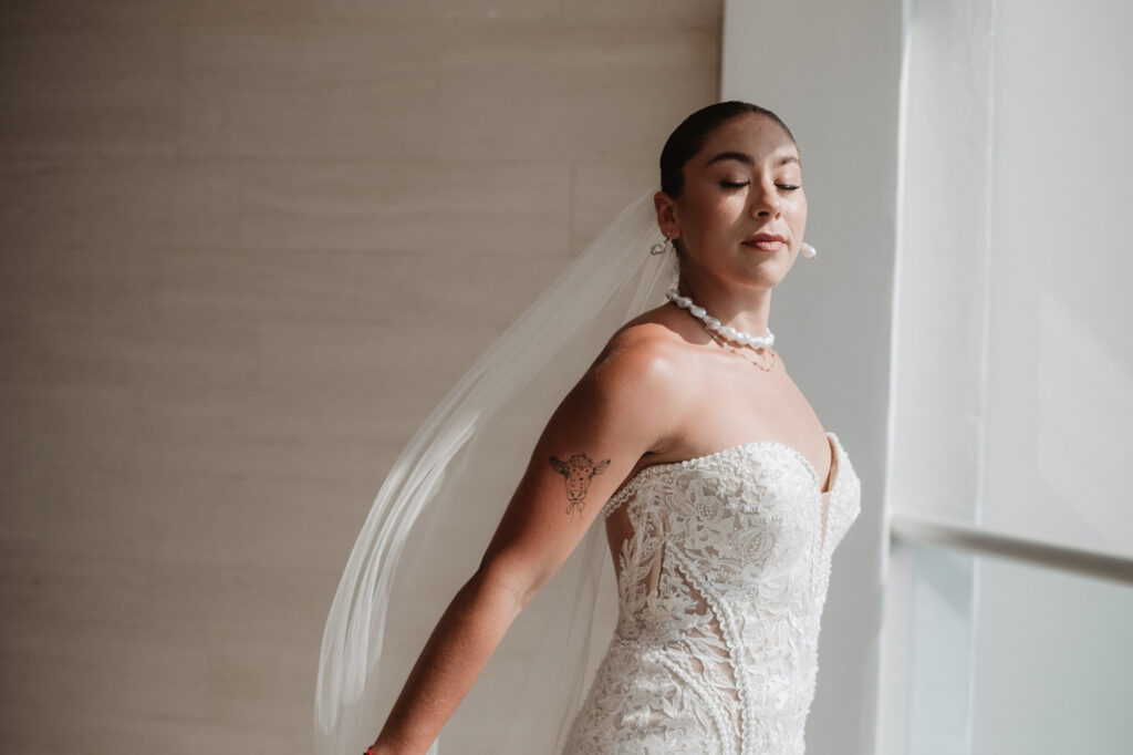 Bride in lace gown and veil at Hilton Puerto Vallarta wedding, documentary style photo by Alex Obregón