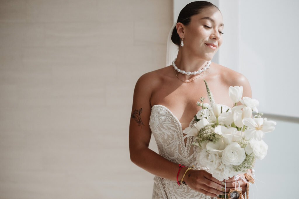 Bride holding white bouquet at Hilton Puerto Vallarta wedding, documentary photography by Alex Obregón