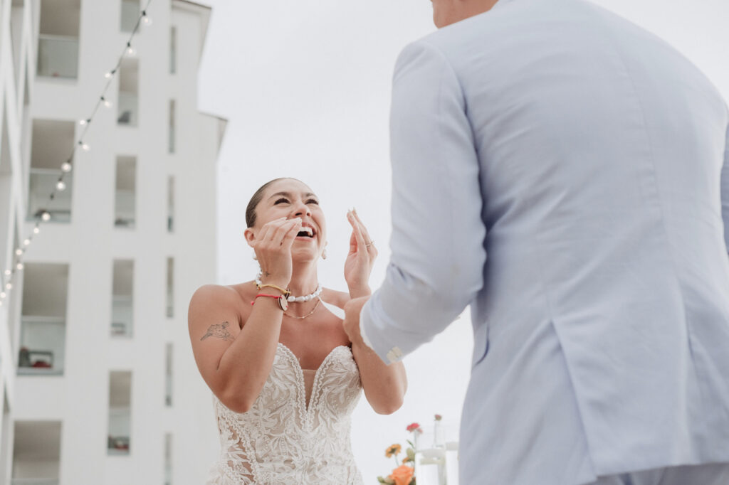 Bride laughing with tears of joy during wedding ceremony at Hilton Puerto Vallarta, Mexico