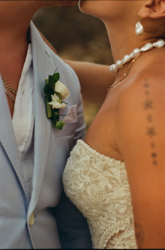 Wedding couple close-up at Hilton Puerto Vallarta, boutonniere and lace dress detail, film photography
