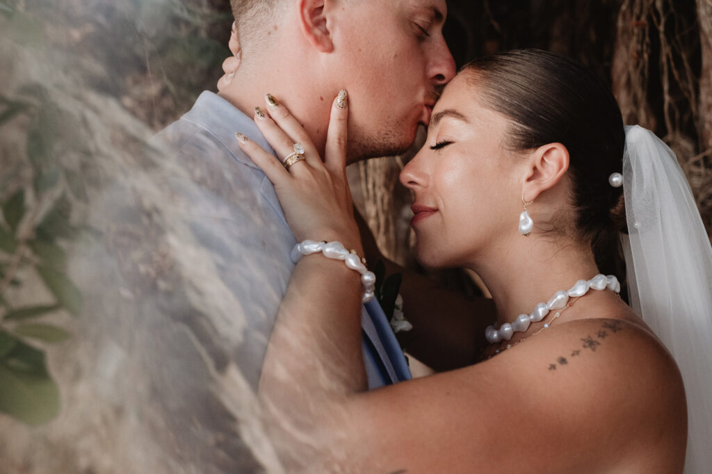Bride and groom sharing a kiss at Hilton Riviera Vallarta, Puerto Vallarta wedding photography by Alex and Dani Obregon