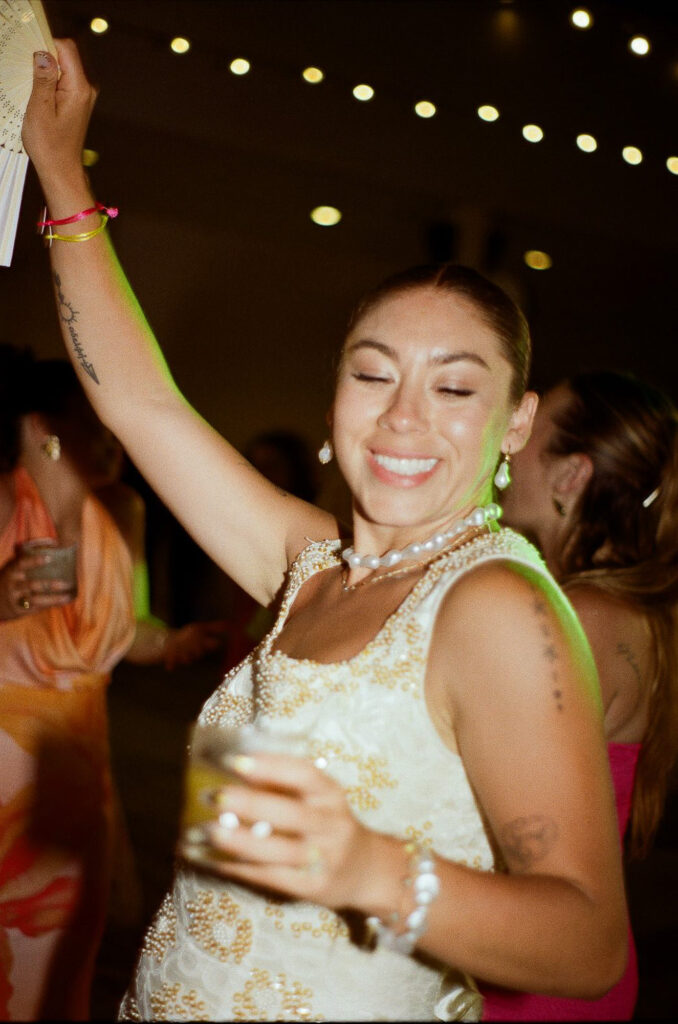 Bride dancing joyfully at wedding reception, Hilton Puerto Vallarta, film photography by Alex Obregón