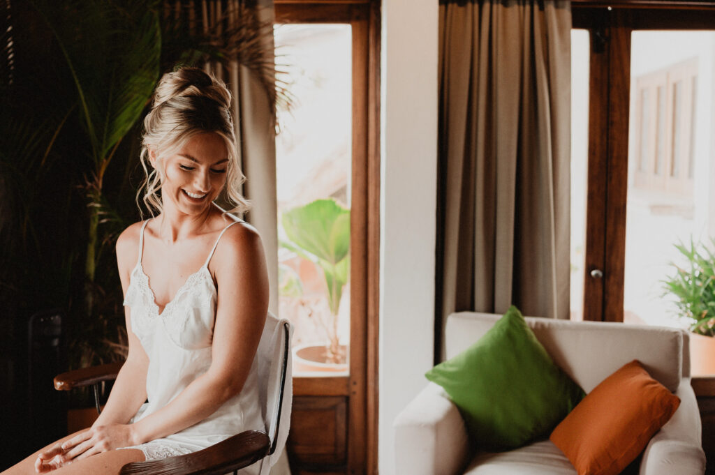 Bride smiling while getting ready at Casa Cosmos, Puerto Vallarta wedding photography by Alex Obregón