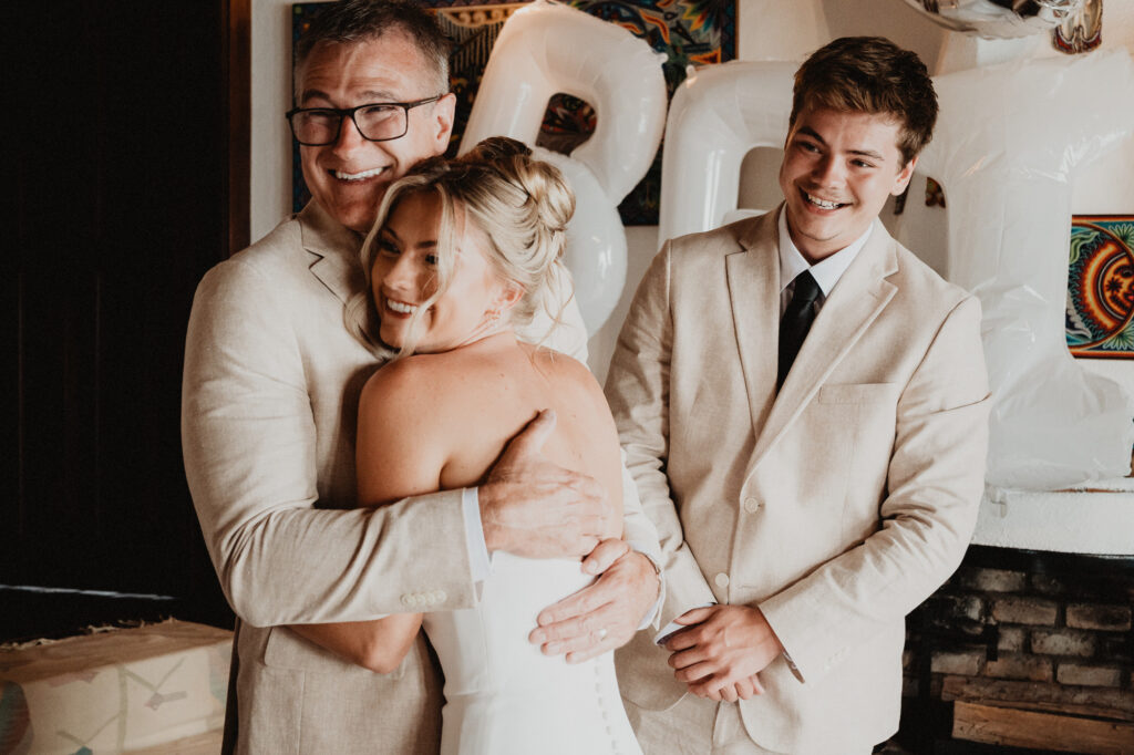 Bride hugging family member at wedding reception, Casa Cosmos Puerto Vallarta, documentary style