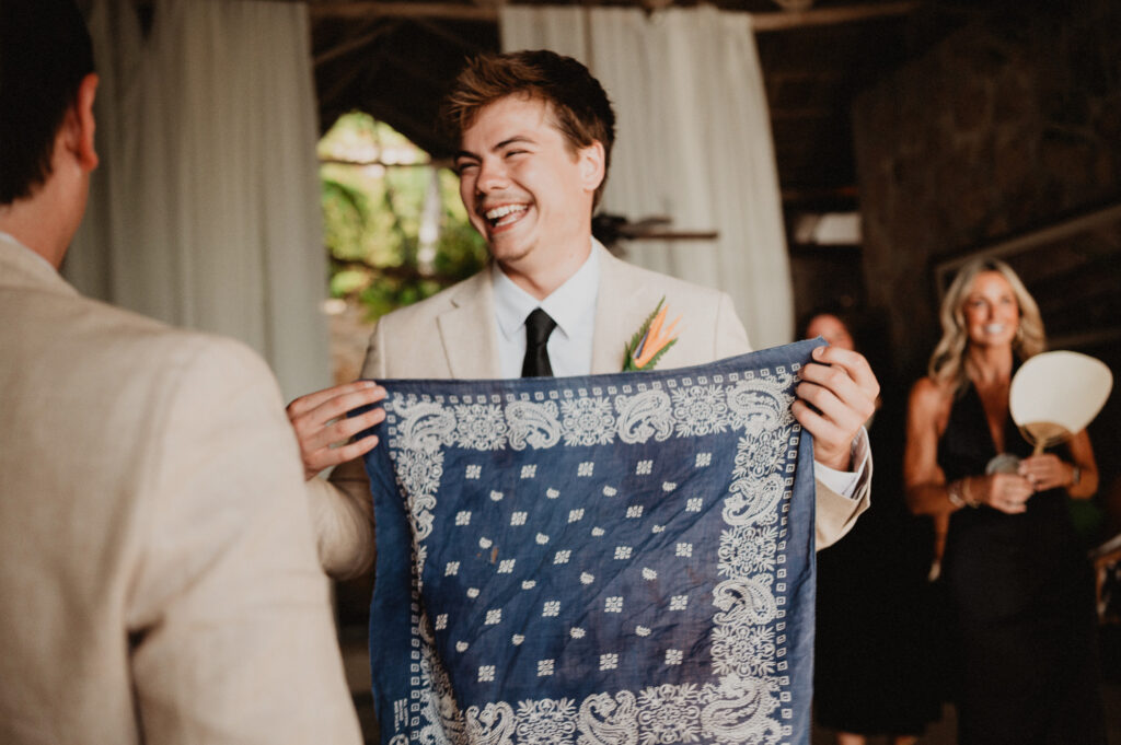 Groom laughing while holding blue bandana at wedding ceremony, Casa Cosmos Puerto Vallarta