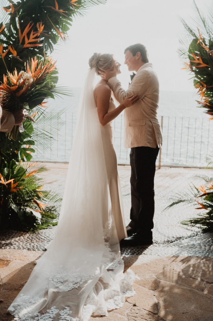 Bride and groom sharing a tender moment during wedding ceremony at Casa Cosmos, Puerto Vallarta