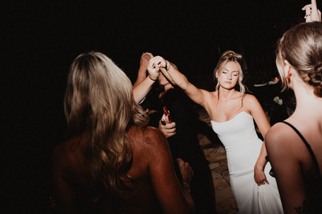 Bride dancing with guests at wedding reception, Casa Cosmos Puerto Vallarta, documentary style