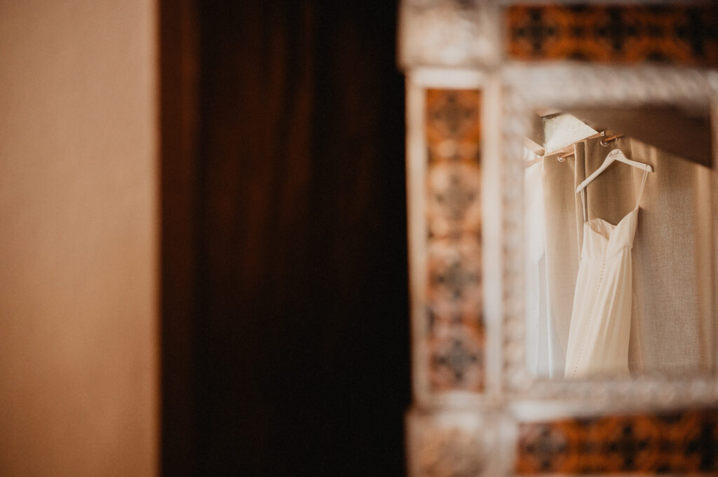 Wedding dress hanging in mirror at Casa Cosmos Puerto Vallarta, captured by destination wedding photographer