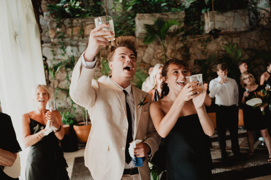 Wedding guests raising glasses in a toast at Casa Cosmos reception, Puerto Vallarta