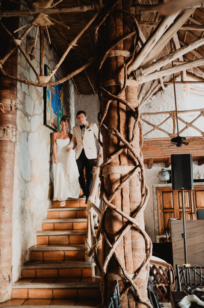 Bride and groom descending rustic staircase at Casa Cosmos, Puerto Vallarta wedding reception