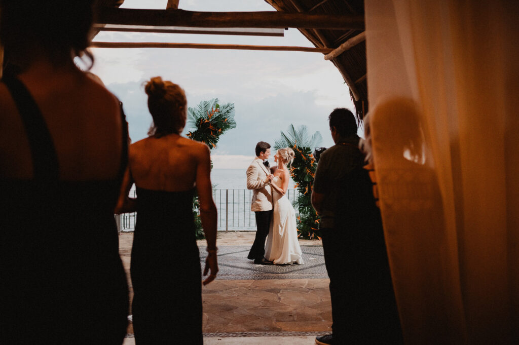 Bride and groom share first dance at Casa Cosmos Puerto Vallarta with ocean view backdrop